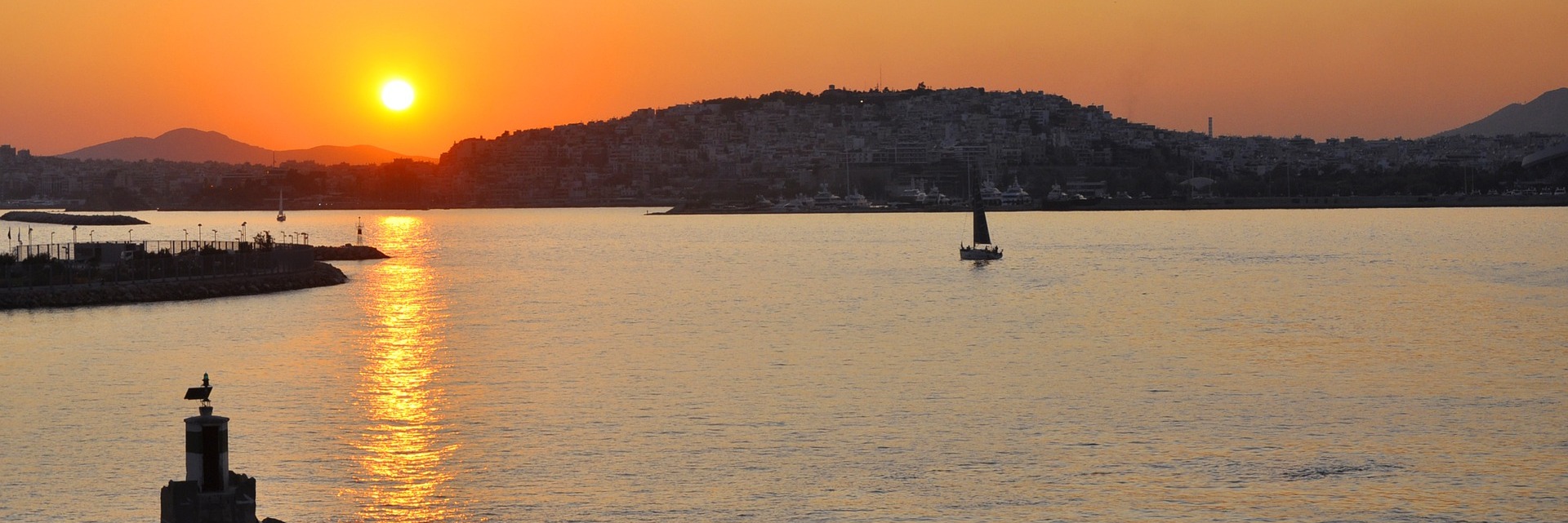 Yacht charter Athens: a yacht sailing at sunset off the Athens coast