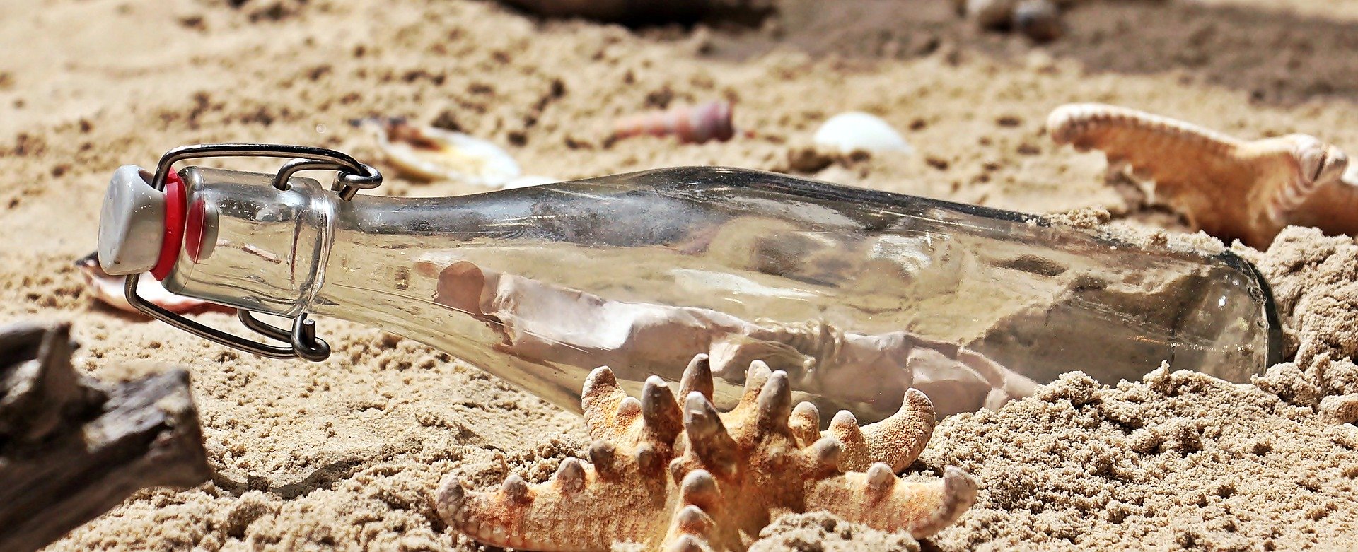 A message in a bottle on a sandy beach