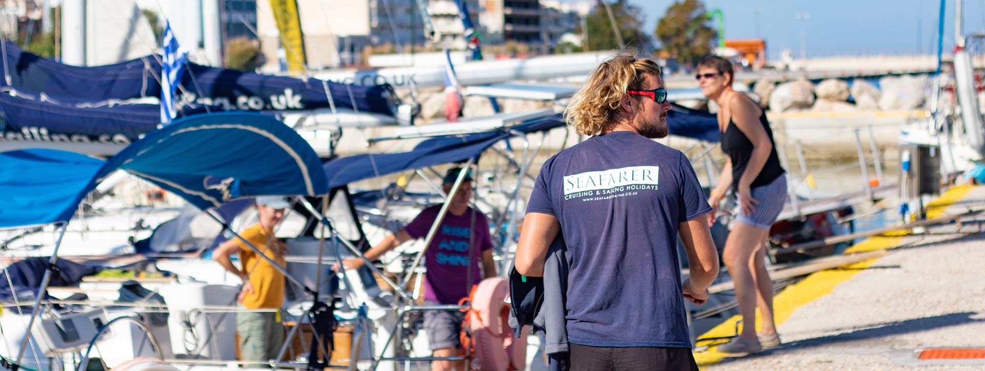 Seafarer crew on the quay beside the flotilla yachts