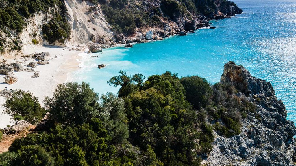Agiofili beach on Lefkas, with white cliffs, green hills and turquoise water