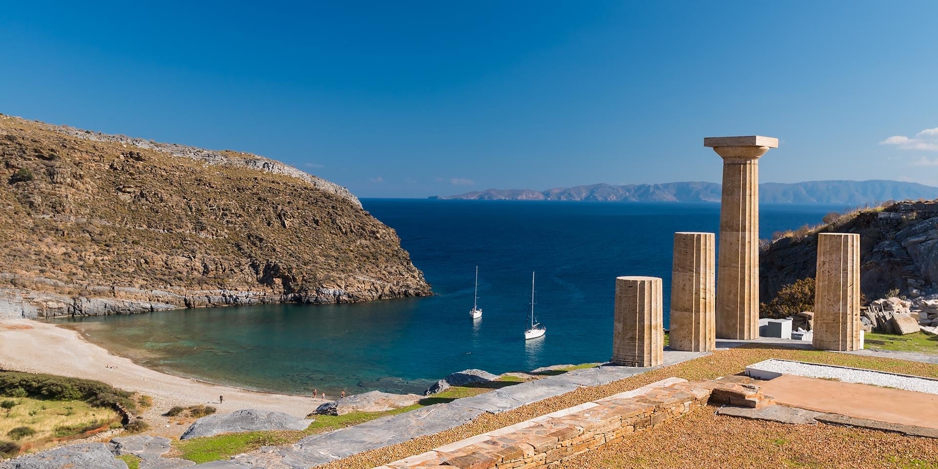 Yacht charter Lavrion: ancient columns above a bay on Kea, 14 miles from Lavrion
