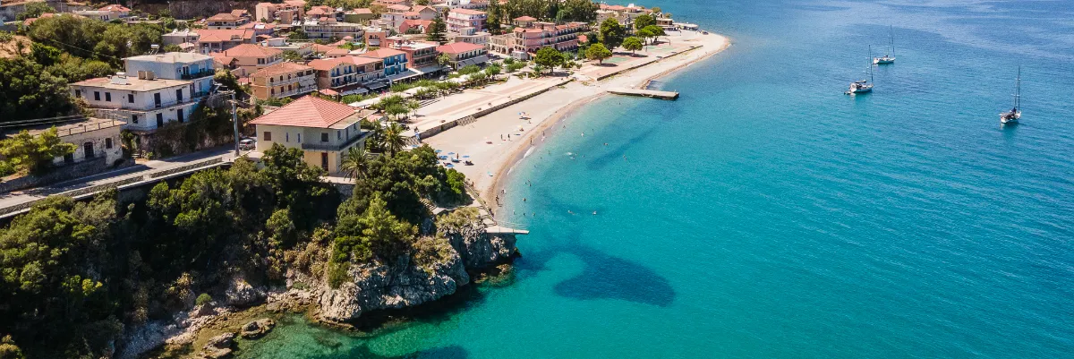 Aerial view of Poros on Kefalonia, with its beach, harbour, and turquoise water