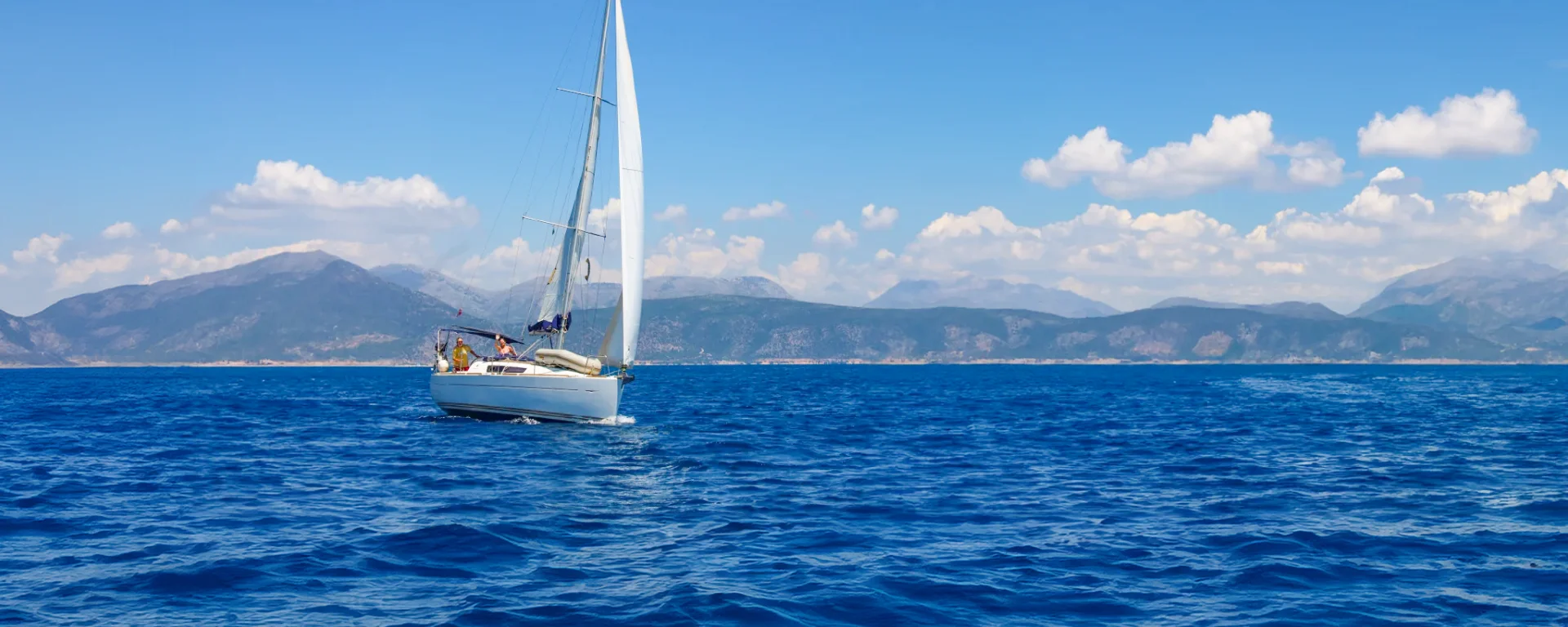 A Sun Odyssey 33i flotilla yacht under sail in the Ionian