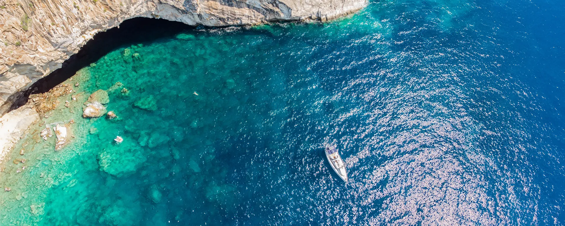 Bavaria 37 Stairway to Heaven anchored near a sea cave
