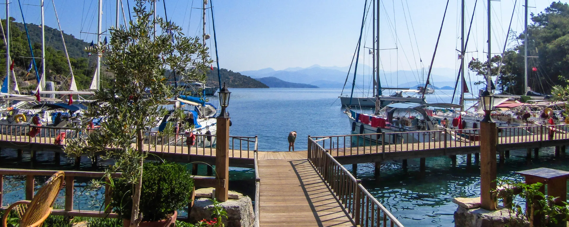 Yachts moored at a restaurant jetty in the Gulf of Fethiye