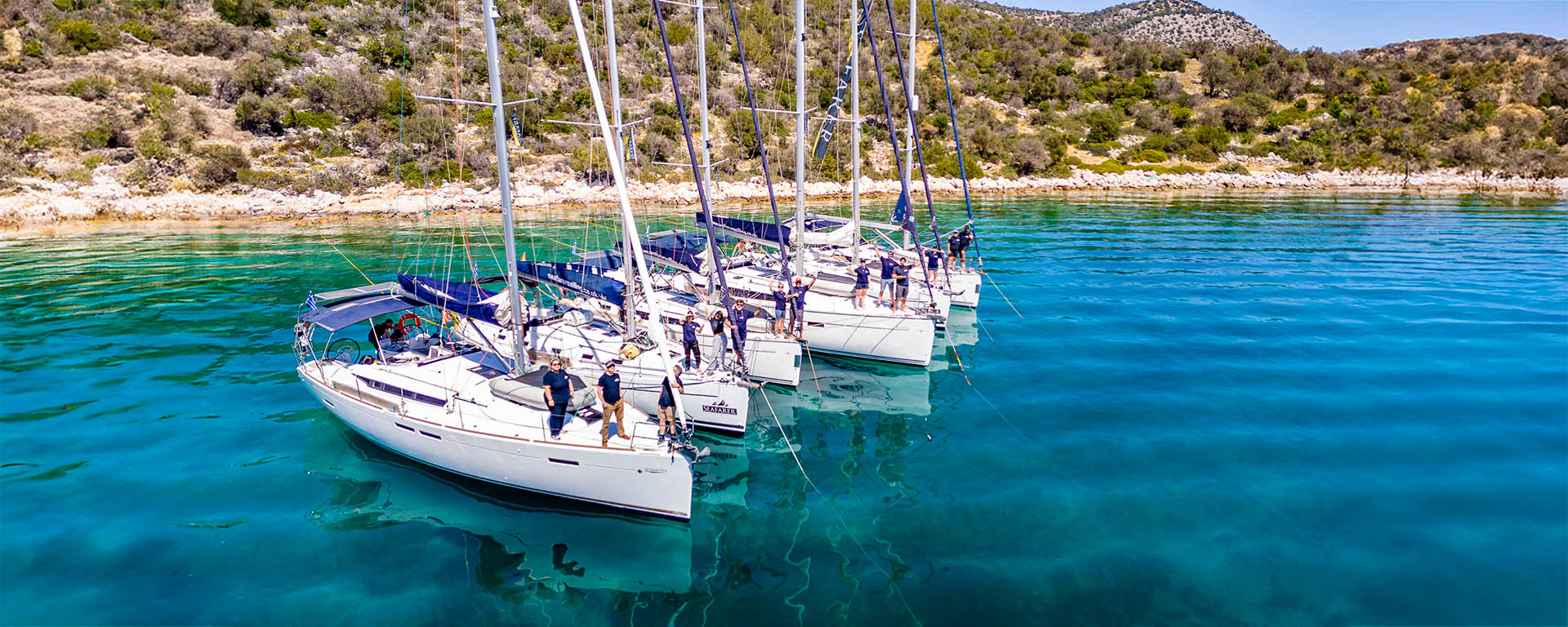 Seafarer yachts rafted together in a turquoise Greek bay