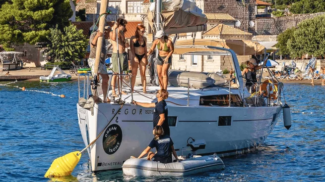 Seafarer crew in the dinghy, helping a flotilla yacht