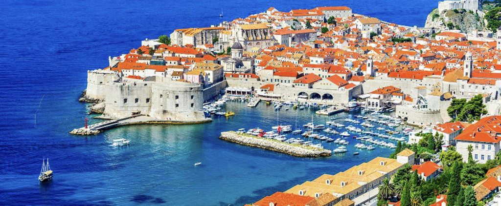 A stunning view of Croatia’s Dalmatian coastline with turquoise Adriatic waters and historic orange-roofed towns