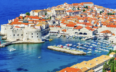 A stunning view of Croatia’s Dalmatian coastline with turquoise Adriatic waters and historic orange-roofed towns