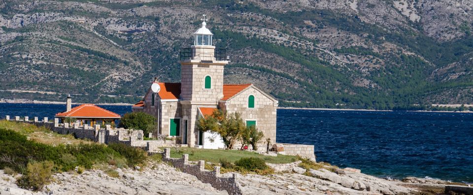 Hvar Island’s chic harbour with turquoise waters, historic architecture, and a peaceful lighthouse setting.