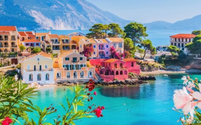 Vibrant pastel-coloured houses overlooking the turquoise waters of Assos, Kefalonia, a highlight of Greek sailing holidays.