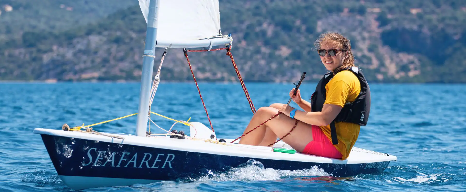 A student confidently sailing solo in a dinghy at Seafarer Academy training centre