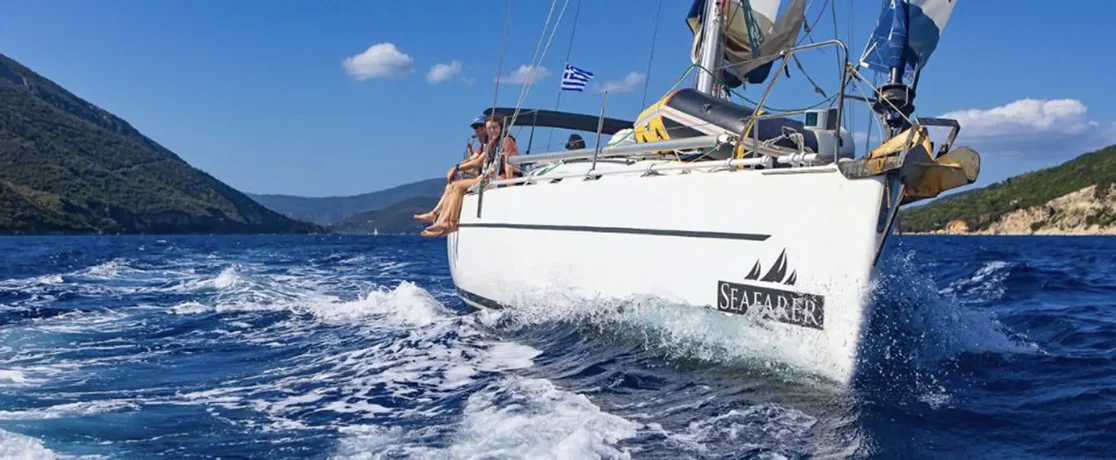 A Seafarer yacht sailing in Greece, with guests on the foredeck