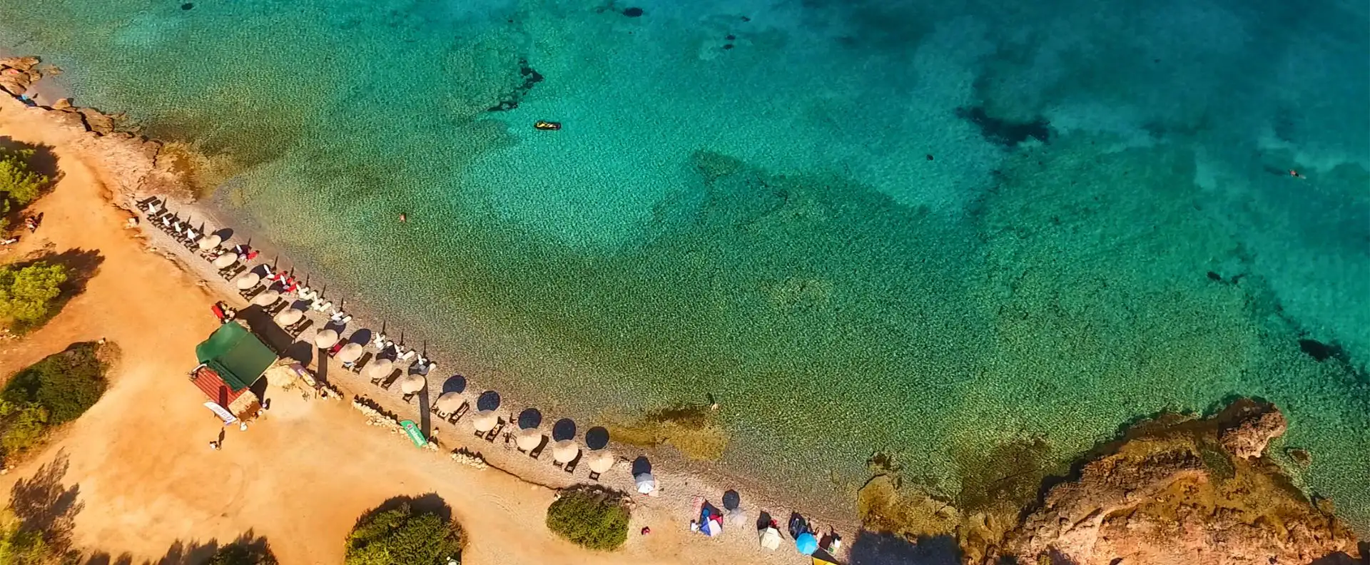 A beautiful Greek island beach, a must-visit destination for sailors with the right sailing gear