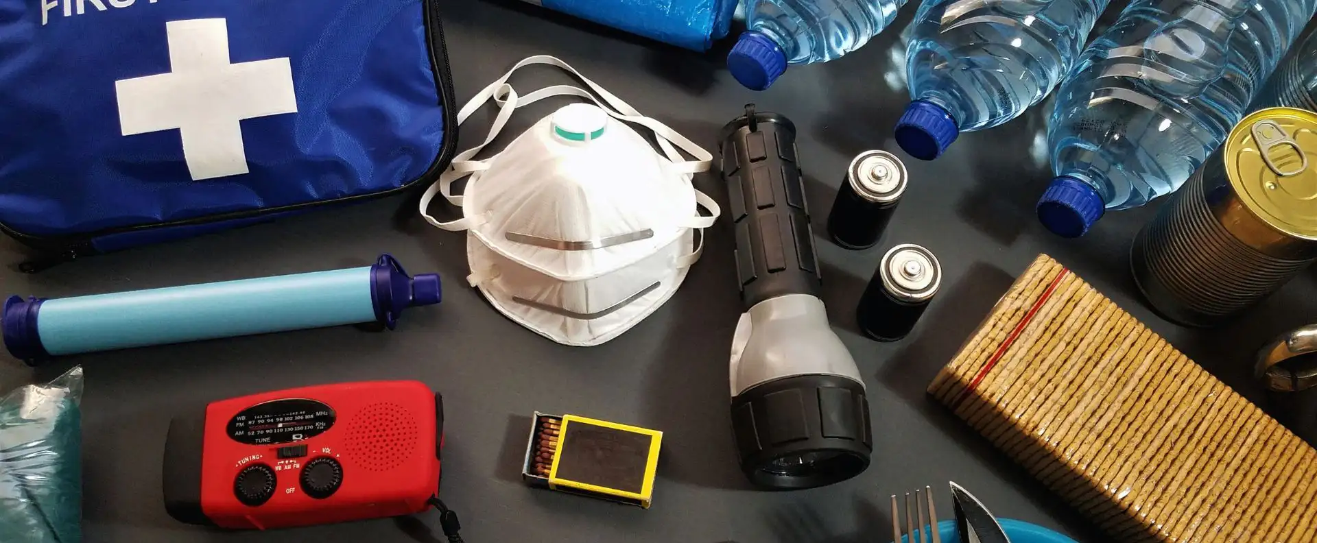 Essential sailing gear for safety, including a first-aid kit, waterproof flashlight, and emergency supplies