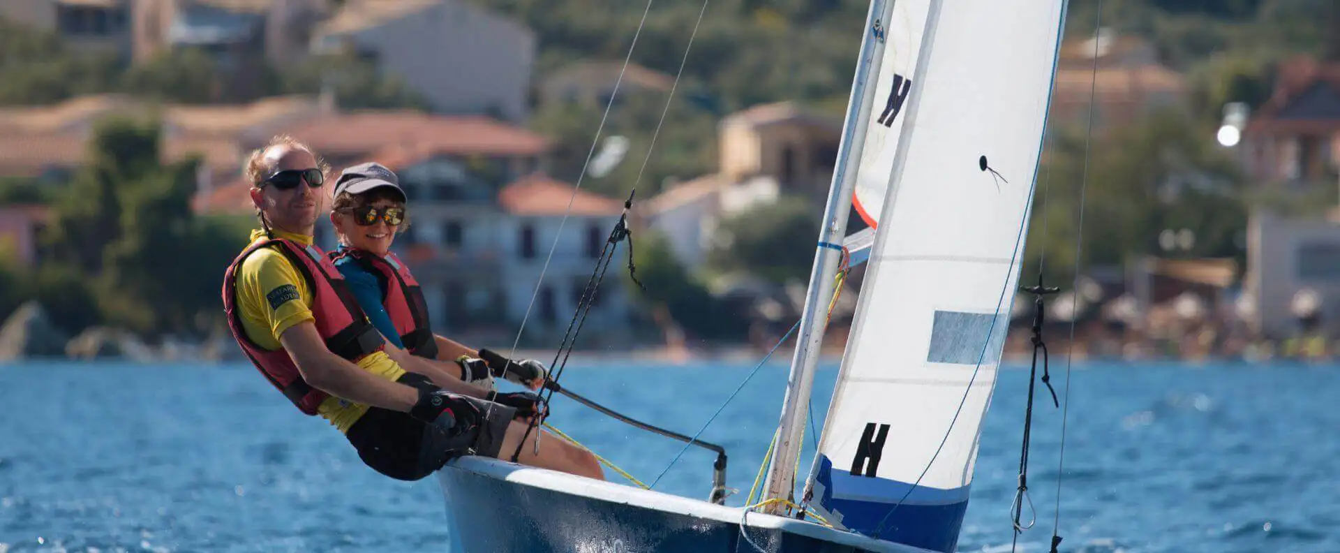 Female sailor practising dinghy sailing during the RYA Dinghy Instructor Course in Greece