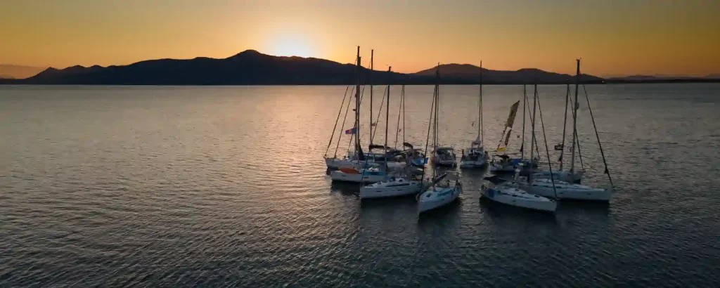 Flotilla yachts rafted together at sunset on a sailing holiday in the Ionian