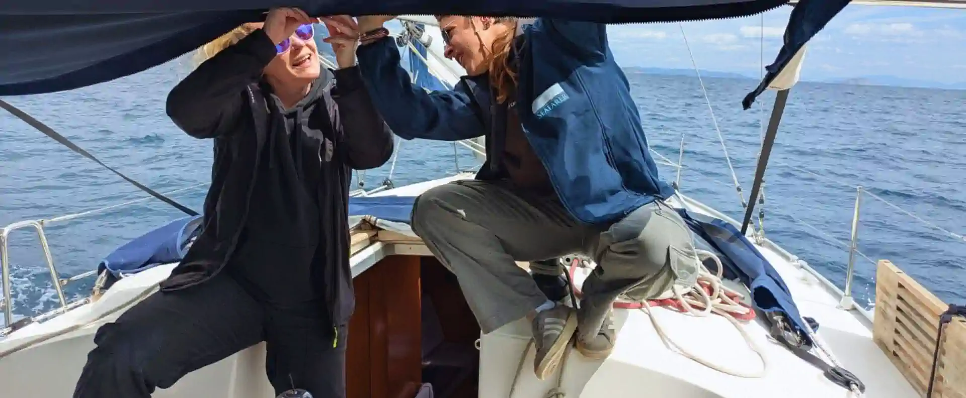 Seafarer crew teamwork adjusting a sail during training