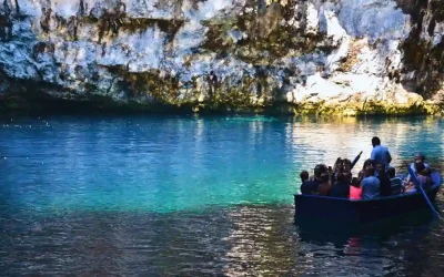 Small group on a boat tour inside a turquoise cave lake in the Ionian Islands