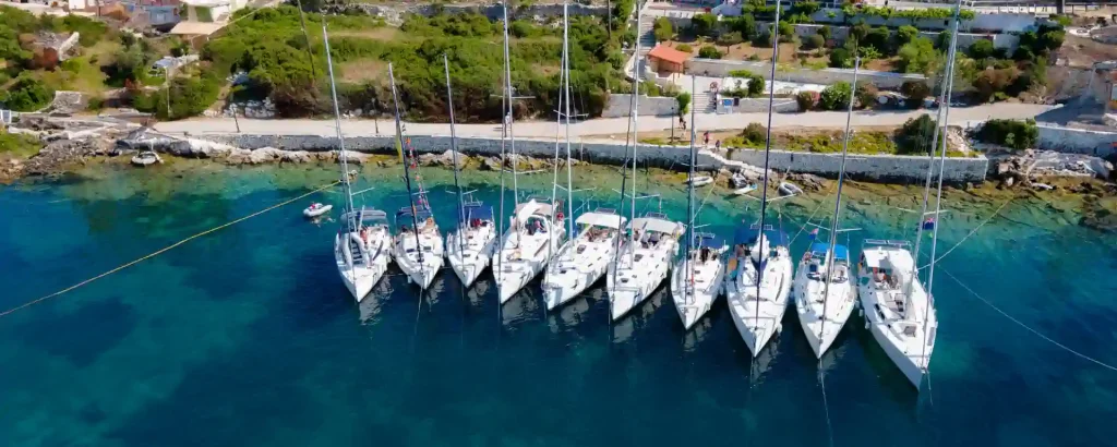 Flotilla of sailing yachts moored in Fiskardo, Greece during a flotilla sailing holiday – Seafarer Sailing
