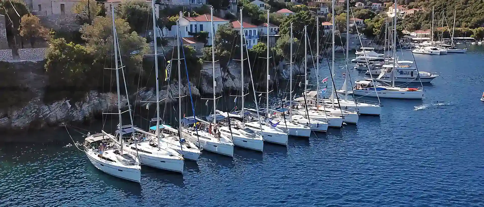 Flotilla sailing holidays in Greece: Seafarer yachts moored side by side in a Greek island harbour