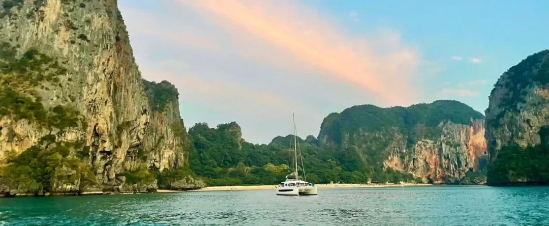 Catamaran anchored off Railay Beach at sunset