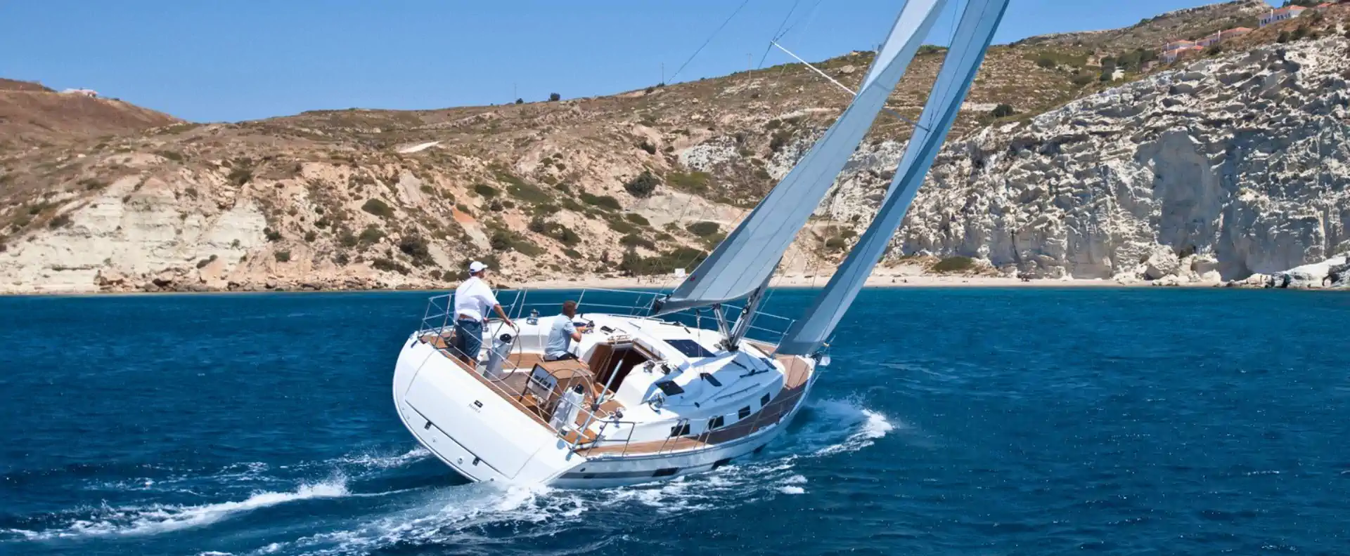 sailing blogs yacht charter tips greece A sailing yacht navigating clear blue waters along the Greek coast, featured in Seafarer’s top sailing blogs.