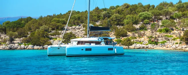 A catamaran anchored in a turquoise bay