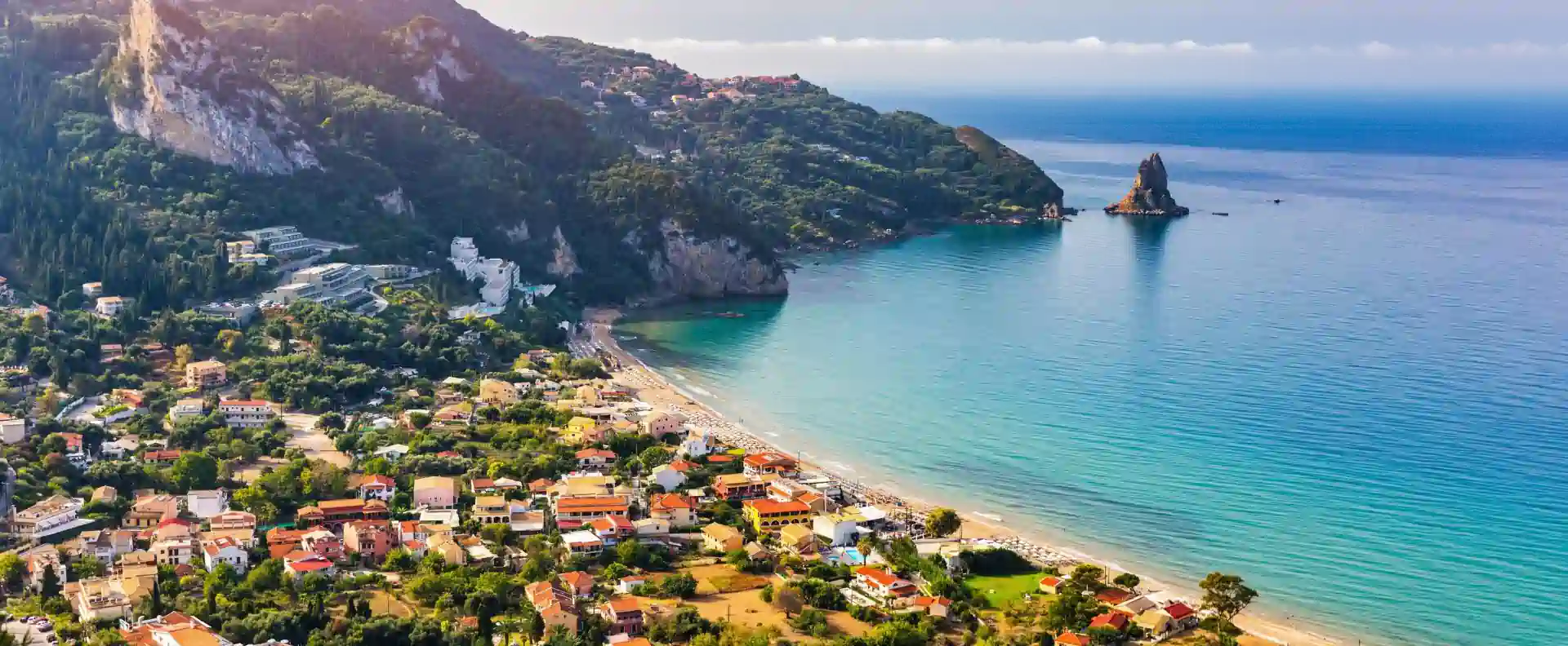 Agios Gordios bay on Corfu’s west coast with beach, headland and calm water