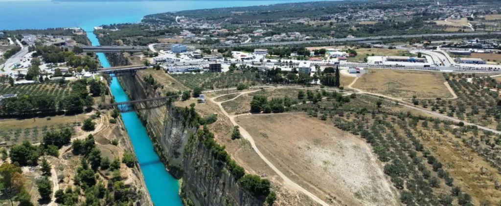 Aerial view of the Corinth Canal in Greece, showing the narrow waterway linking the Saronic and Corinthian gulfs.