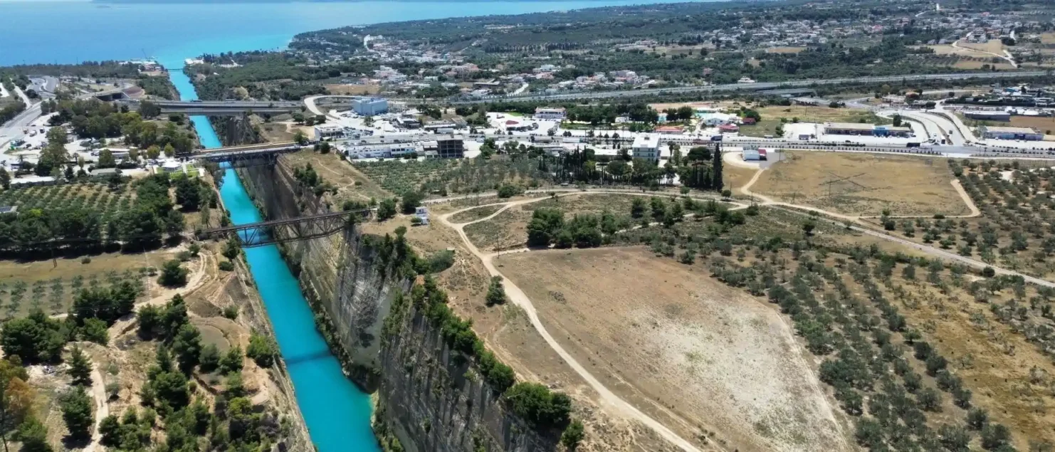Aerial view of the Corinth Canal in Greece, showing the narrow waterway linking the Saronic and Corinthian gulfs.