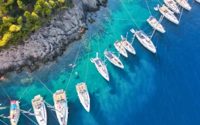 Kefalonia flotilla yachts Ionian bay Aerial view of flotilla yachts moored in clear blue water while sailing around Kefalonia, Assos