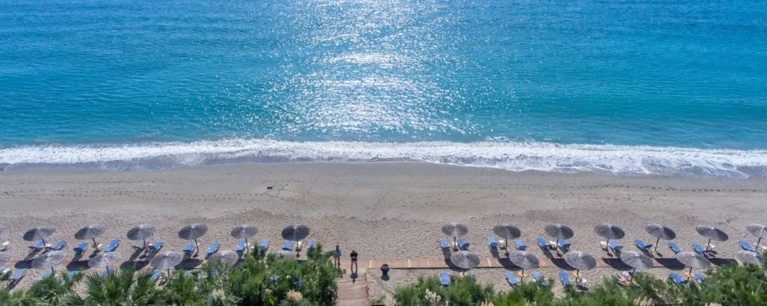 Sun loungers on the beach at Poseidon Beach Club