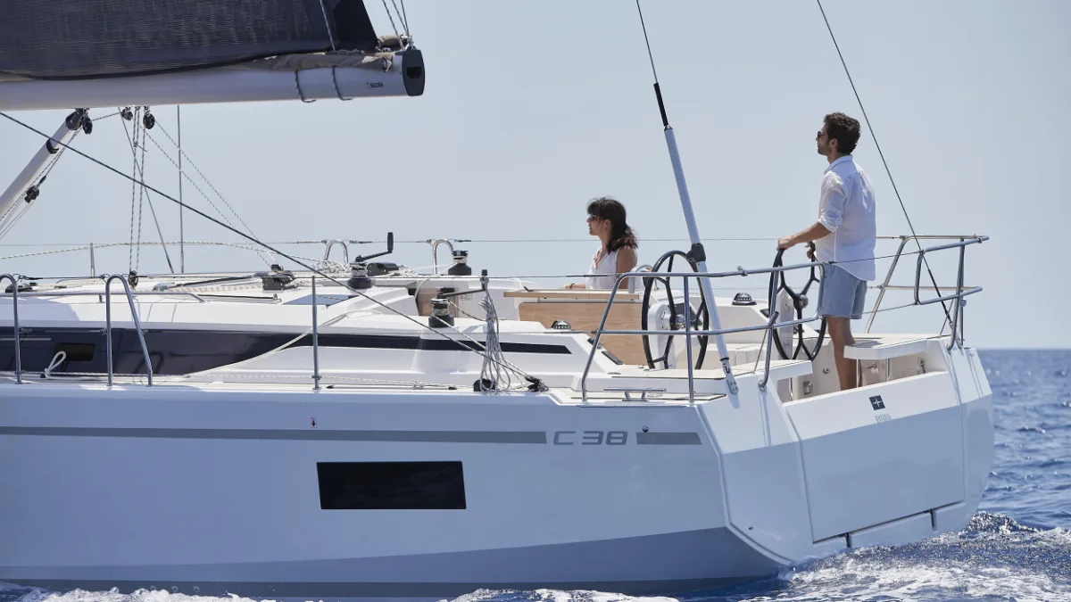 Guests in the cockpit of a Bavaria C38 under sail