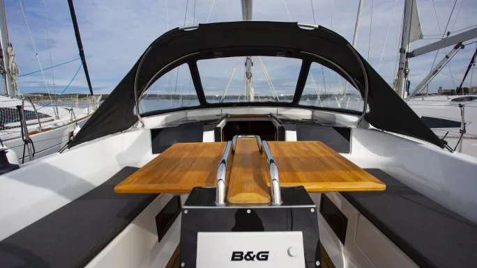 The cockpit table and twin wheels of a Hanse 388
