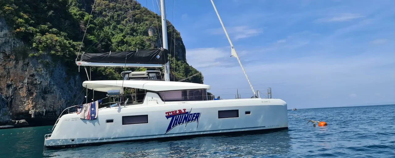 Thai Thunder, a Lagoon 42 catamaran, sailing past limestone cliffs in Thailand