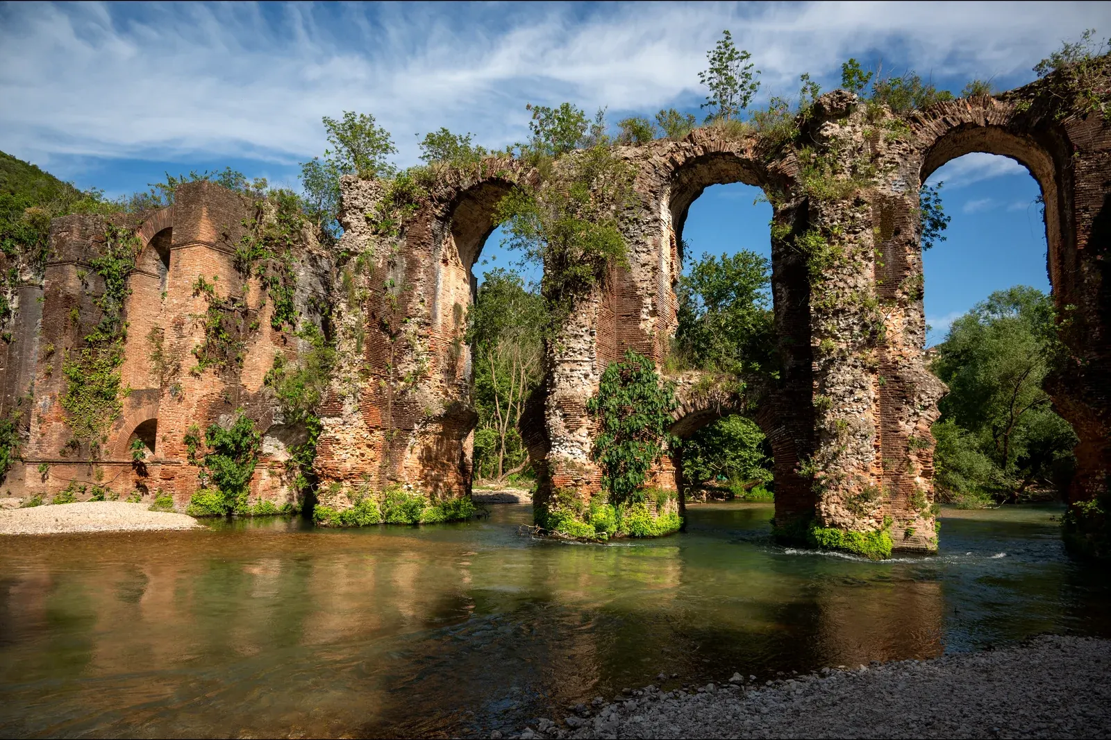 The arches of the Roman aqueduct that carried water to Nikopolis, standing in the Louros river near Preveza