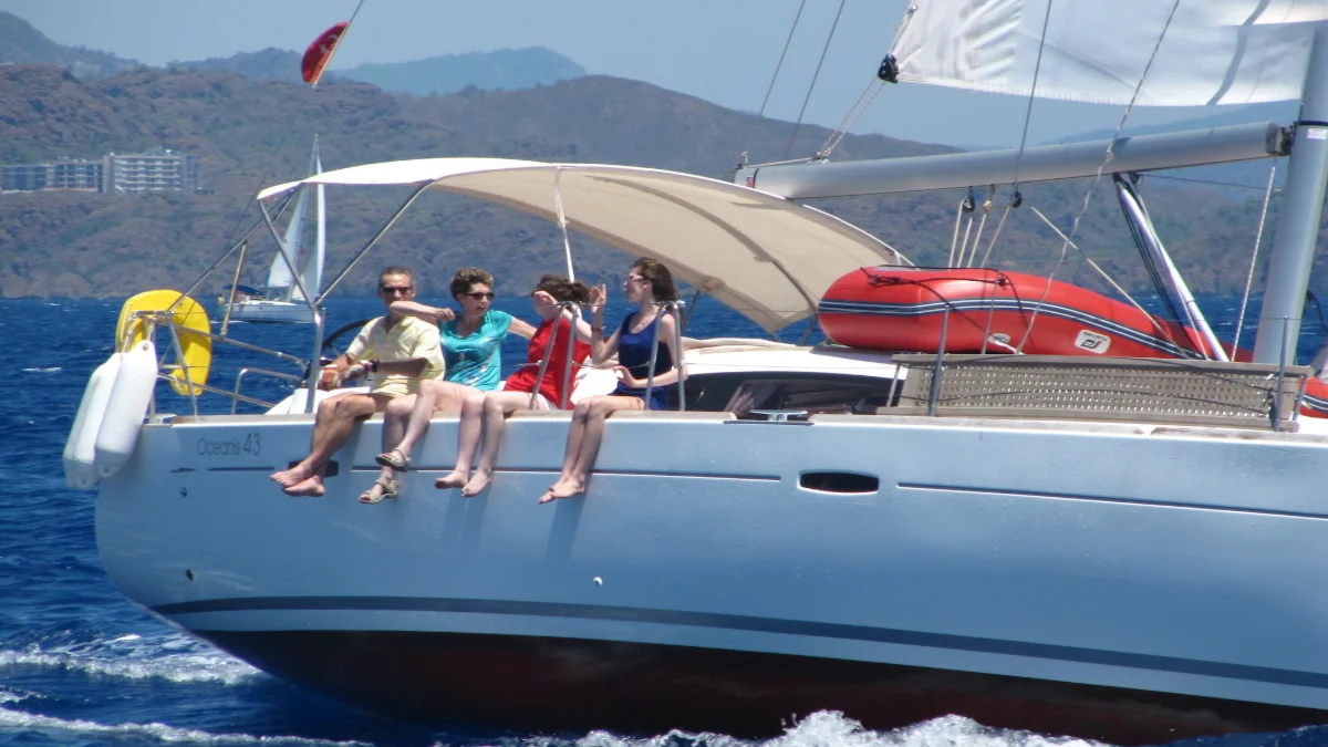 Guests on the foredeck of the Oceanis 43 under sail